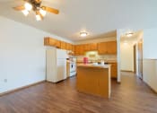 Thumbnail 6 of 9 - a kitchen with white appliances and wooden cabinets.  Fargo, ND Hunters Run Apartments