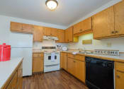 Thumbnail 5 of 9 - a kitchen with white appliances.  Fargo, ND Hunters Run Apartments