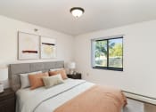 Thumbnail 3 of 23 - a bedroom with a bed and nightstands. Hutchinson, MN Deer Park Apartments
