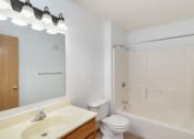 Thumbnail 13 of 23 - a bathroom with a sink toilet and shower and a mirror. Hutchinson, MN Deer Park Apartments