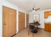 Thumbnail 5 of 23 - a dining room with a table and a ceiling fan. Hutchinson, MN Deer Park Apartments