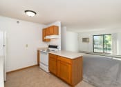 Thumbnail 8 of 23 - an empty kitchen with a stove and a refrigerator. Hutchinson, MN Deer Park Apartments