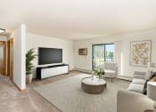 Thumbnail 4 of 23 - a living room filled with furniture and a large tv. Hutchinson, MN Deer Park Apartments
