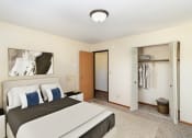 Thumbnail 4 of 11 - a bedroom with a large bed and a closet. Hutchinson, MN Echo Manor Apartments