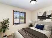 Thumbnail 3 of 11 - a bedroom with a bed and a window and a plant. Hutchinson, MN Echo Manor Apartments
