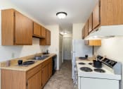 Thumbnail 6 of 11 - a kitchen with a stove and a sink and a refrigerator. Hutchinson, MN Echo Manor Apartments