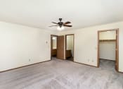 Thumbnail 15 of 18 - an empty living room with a ceiling fan and a closet. Hutchinson, MN Twin Oaks