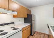 Thumbnail 13 of 18 - a kitchen with white appliances and wooden cabinets and a refrigerator. Hutchinson, MN Twin Oaks