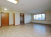 Thumbnail 2 of 21 - a living room with the entry door and a window.