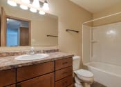 Thumbnail 10 of 12 - Grand Forks, ND Madison Apartments. A bathroom with a sink, toilet, and bathtub.