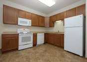 Thumbnail 2 of 23 - a kitchen with white appliances and wooden cabinets. Fargo, ND North Sky Apartments