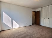 Thumbnail 15 of 18 - a bedroom with white walls and a carpet. Fargo, ND Kingswood Apartments