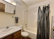 Thumbnail 11 of 18 - a bathroom with a shower sink and toilet. Fargo, ND Kingswood Apartments