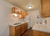 Thumbnail 7 of 18 - a kitchen with white appliances and wooden cabinets and a white refrigerator