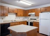 Thumbnail 6 of 14 - a kitchen with white and black appliance. Fargo, ND Kentwood Manor Apartments
