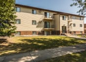 Thumbnail 11 of 12 - Grand Forks Kremer Apartments. Exterior of a three level building