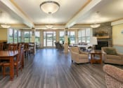 Thumbnail 11 of 21 - a community room with tables and chairs. Fargo, ND Sunrise North