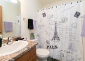 Thumbnail 13 of 13 - a bathroom with a sink and a toilet and a shower. Fargo, ND White Ridge Apartments