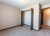Thumbnail 13 of 20 - Grand Forks, ND Library Lane Apartments a bedroom with a closet and an open door