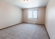 Thumbnail 14 of 20 - Grand Forks, ND Library Lane Apartments a large empty room with a window