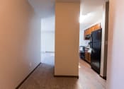 Thumbnail 12 of 20 - Grand Forks, ND Library Lane Apartments a view of the kitchen and living room from the hallway