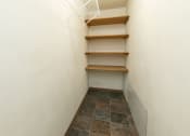 Thumbnail 24 of 34 - a walk in closet with shelves and a white wall. Fargo, ND Islander Apartments
