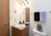 Thumbnail 12 of 13 - a bathroom with a sink and toilet. Fargo, ND White Ridge Apartments