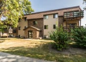 Thumbnail 1 of 12 - Grand Forks, ND Madison Apartments. The exterior of a three story apartment building