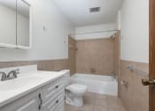 Thumbnail 25 of 32 - a bathroom with a sink toilet and a bath tub. Maplewood, MN Maplewood Apartments