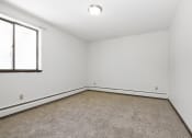 Thumbnail 21 of 32 - an empty room with carpet and a window. Maplewood, MN Maplewood Apartments