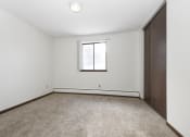 Thumbnail 23 of 32 - an empty room with a window and a closet. Maplewood, MN Maplewood Apartments