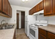 Thumbnail 17 of 32 - a kitchen with white appliances and wooden cabinets. Maplewood, MN Maplewood Apartments