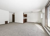 Thumbnail 16 of 32 - an empty living room with a ceiling fan and a window. Maplewood, MN Maplewood Apartments