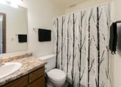 Thumbnail 18 of 20 - a bathroom with a shower and a sink and a toilet. Fargo, ND Maplewood Bend Apartments