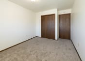 Thumbnail 17 of 20 - a bedroom with carpet and a closet. Fargo, ND Maplewood Bend Apartments