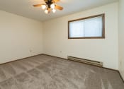 Thumbnail 11 of 20 - a bedroom with carpet and a ceiling fan. Fargo, ND Maplewood Bend Apartments