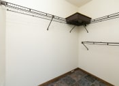 Thumbnail 12 of 20 - a room with two hanging racks on the wall and a tile floor. Fargo, ND Maplewood Bend Apartments