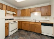 Thumbnail 8 of 20 - a kitchen with white appliances and wooden cabinets. Fargo, ND Maplewood Bend Apartments