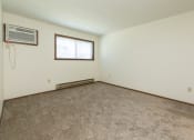 Thumbnail 6 of 20 - an empty living room with carpet and a window .Fargo, ND Maplewood Bend Apartment