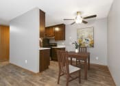 Thumbnail 2 of 32 - dining area in Maplewood Apartments 11A. The dining room is furnished with a modern table and chairs, providing a sleek and inviting setting for meals.