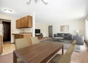 Thumbnail 5 of 32 - A dining area in Maplewood Apartments 21B. The room has a 4 chair table with the living room in the background