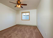 Thumbnail 12 of 17 - a bedroom with a ceiling fan and a window. Fargo, ND Maybrook Apartments