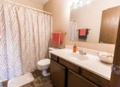 Thumbnail 14 of 16 - Grand Forks, ND Mayfair Apartments a bathroom with a toilet sink and shower