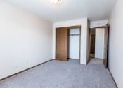 Thumbnail 11 of 16 - Grand Forks, ND Mayfair Apartments a bedroom with white walls and carpet