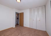 Thumbnail 7 of 15 - a bedroom with a closet and a door to a bathroom. Fargo, ND Morningside Apartments