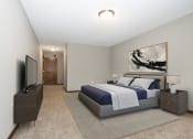 Thumbnail 25 of 32 - Georgetown on the River Apartments, Fridley, Minnesota. A bedroom with a bed and a tv.