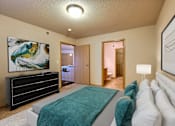 Thumbnail 4 of 12 - a master bedroom with a bed and a tv. Fargo, ND East Bridge Apartments