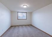 Thumbnail 12 of 16 - a bedroom with a window and carpet. Moorhead, MN South Park Apartments