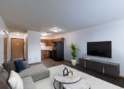 Thumbnail 4 of 16 - a living room with a tv and a kitchen. Moorhead, MN South Park Apartments