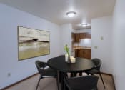 Thumbnail 2 of 16 - a dining room with a table and chairs and a kitchen. Moorhead, MN South Park Apartments